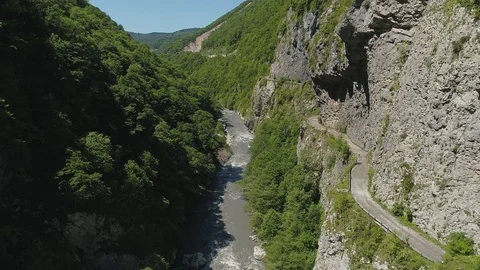 Fly over river in valley with abandoned road Stock Footage 111777697