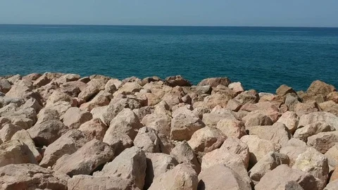 Fly over rocks into the ocean Stock Footage 80626519