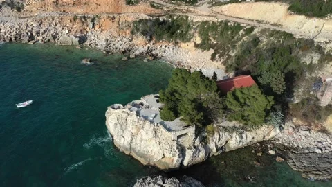 Fly over the sea overlooking a yellow mountain in Montenegro Stock Footage 153555384