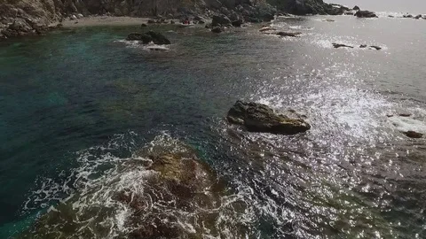 Fly over sea towards island Stock Footage