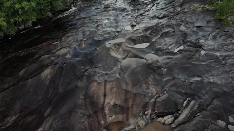 Fly up over a small river tilt reveal Stock Footage 248364602