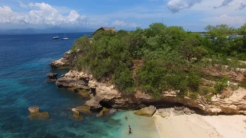 Fly over small rock with luxury villa to the bay Stock Footage 111777841