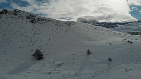 Fly over snow covered hill in Wyoming Stock Footage 166171574