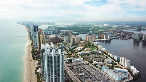 Fly over the sunny isles beach near atlantic ocean with luxurious hotels and Stock Footage 101130376
