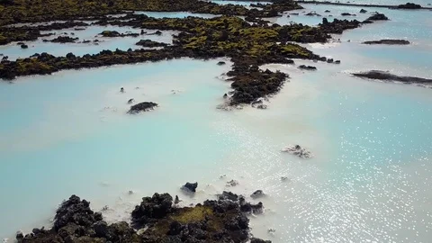 Fly over surreal geothermal pond Stock Footage 102453299