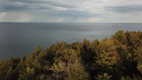 Fly over trees to lake superior Stock Footage 86542180
