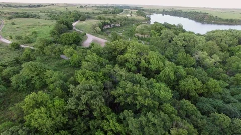 Fly over trees revealing waterfall, river, and lake Stock Footage 80271424