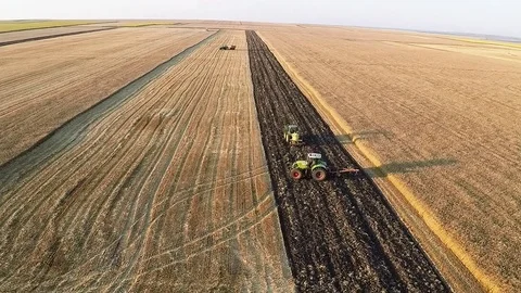 Fly over two plows for autumn plowing Stock Footage 81255394