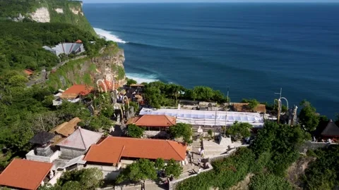 Fly over Uluwatu temple while there is a ceremony Stock Footage 154622836