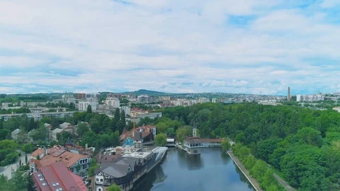 Fly over view cafe and playground near lake shores allocated in city park at Stock Footage 110695336