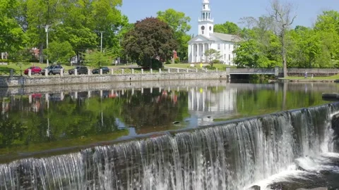 Fly over of a waterfall and lagoon in a small town - approach gentle rise aerial Stock Footage 161414903