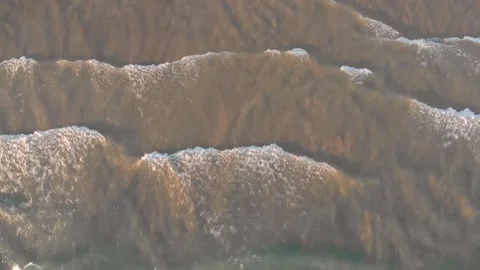 Fly over waves onto the beach Stock Footage