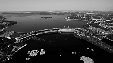 Fly over the weir and power lines of water-power plant. Aerial establishing shot Stock Footage 219894582