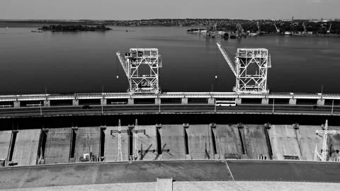 Fly over the weir and power lines of water-power plant. Aerial establishing shot Stock Footage 219895148