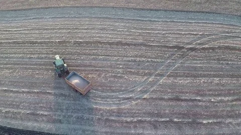 Fly over a wheeled tractor during harvest Stock Footage 81254813