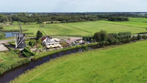Fly over windmill water and terras following lines of trees Video stock 300027760