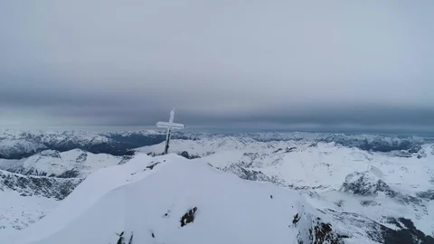 Fly past cross on top of mountain at the top of the Alps Stock Footage 102444488