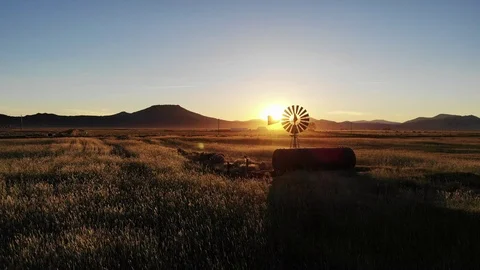 Fly Past Old Windmill on Farm at Sunset - Aerial Drone Stock Footage 114110115