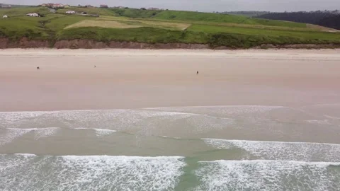 Fly sideways along coast from E to W in playa de Gerra, Cantabria, Spain 4K Stock Footage 155594540