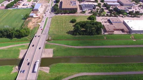 Fly Slow And Low Over Road Stream And Rural Business Complex Stock Footage 65798175
