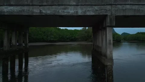 Fly though a bridge above the river with drone and fishing boat. Vídeos de archivo 253726820