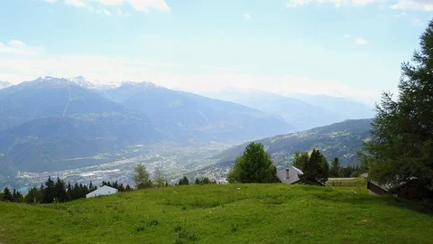 Fly-through close trees and traditional houses in mountains switzerland - green Stock Footage 128695831