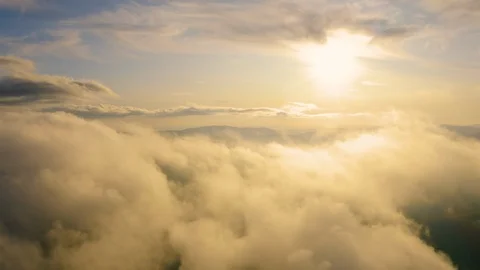 Fly through the Clouds Above Mountain at Sunset. Flying Over Fog at Sunrise. Video stock 118577116