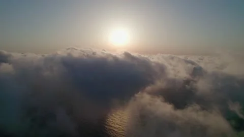 Fly through the clouds during sunrise. An epic shot of clouds in morning colo Stock Footage 160890299