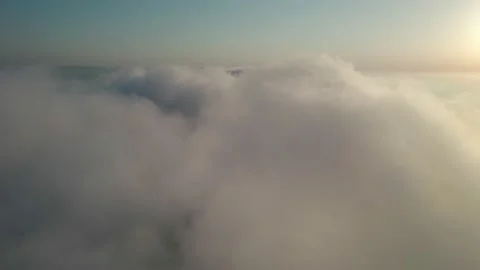 Fly through the clouds during sunrise. An epic shot of clouds in morning colo Stock Footage 163522268