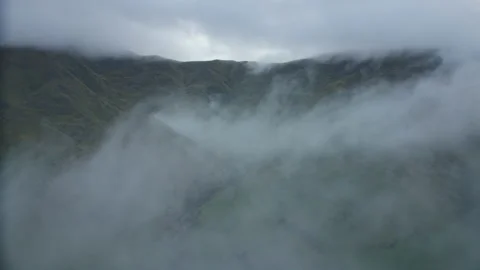 Fly through clouds with hills in distance Stock Footage 192109113