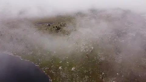 Fly through clouds to mountain lake landscape Stock Footage 312063450