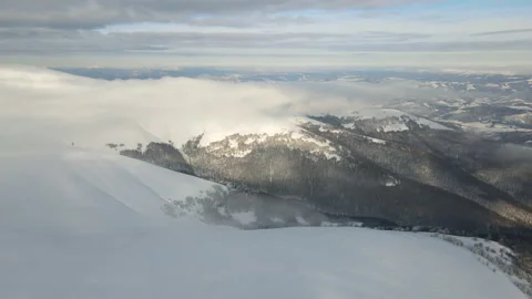 Fly through the clouds over the mountain peaks. Amazing aerial flight over misty Stock Footage 172407447