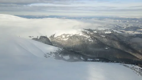 Fly through the clouds over the mountain peaks. Amazing aerial flight over misty Stock Footage 172408283
