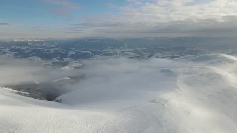 Fly through the clouds over the mountain peaks. Amazing aerial flight over misty Stock Footage 172577675