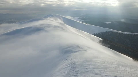 Fly through the clouds over the mountain peaks. Amazing aerial flight over misty Stock Footage 172580384