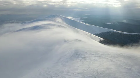Fly through the clouds over the mountain peaks. Amazing aerial flight over misty Stock Footage 175900866