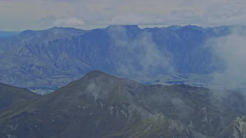 Fly through clouds to see mountains Stock Footage 155525445