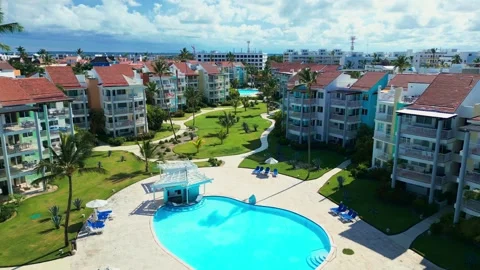 Fly-through palm trees towards luxury tropical residential estate, swimming pool 스톡 동영상 311339287