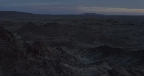 Fly through rocks looking out over martian desolate landscape drone aerial 4K Stock Footage 111309833