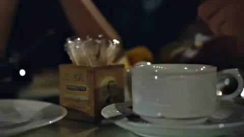 Fly through tea party restaurant table full of dishes in low lighting Stock Footage 124524093