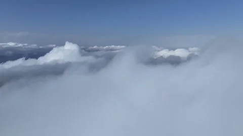 Fly Through White Clouds in Blue Sky with Bright Daylight Above Stock Footage 341883533