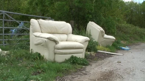 Fly tipping of two old sofas 06 Video stock 49952341