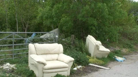 Fly tipping of two old sofas 07 Video stock 49952367