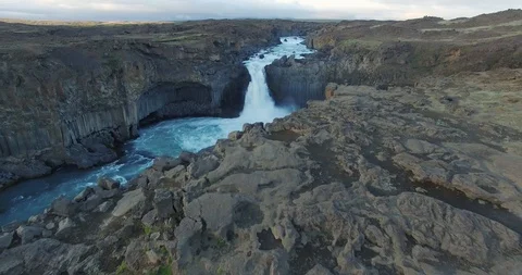 Fly towards and over big icelandic waterfall at sunset Video stock 107542502