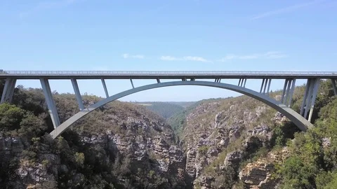 Fly under bridge spanning across natural valley Video stock 71612655