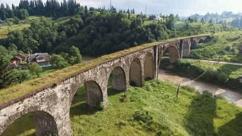 Fly under old arched bridge Stock Footage