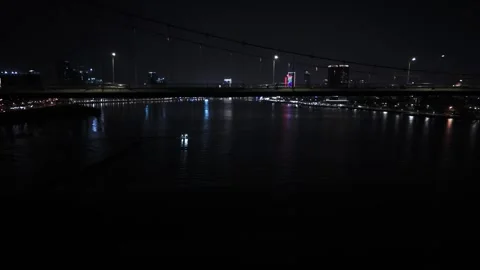 Fly under Thuan Phuoc Bridge towards boat at night in Da Nang, Vietnam Видео 332806108
