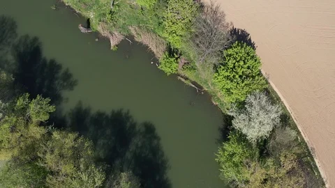 Fly view above dead river channel in central European lowlands during spring, 4K Stock Footage 107374568