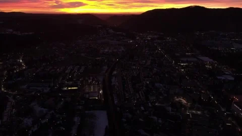 Flyback over idyllic town in the early morning revealing dramatic fire red sky Stock Footage 147900331