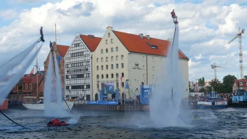 Flyboard acrobatics show, dynamic tricks, tree riders Stock Footage 93687407